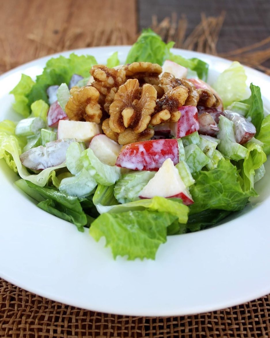 A Waldorf salad inside of a white bowl